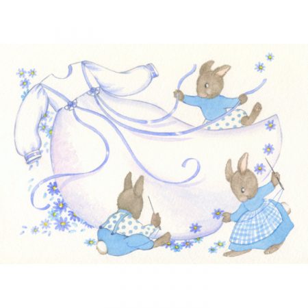 Greetings card design with three rabbits sewing a white baby boy gown with blue ribbons